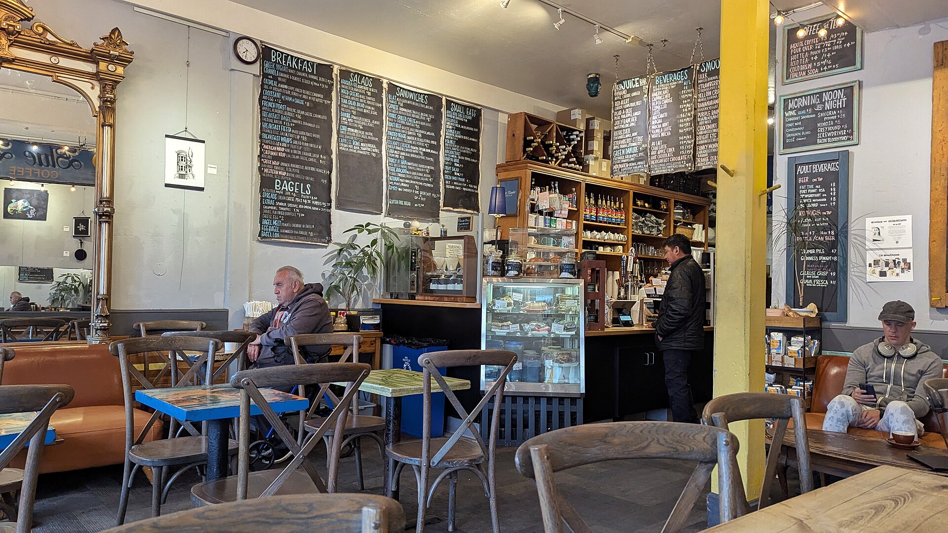 A neighborhood café with a long counter and small tables
