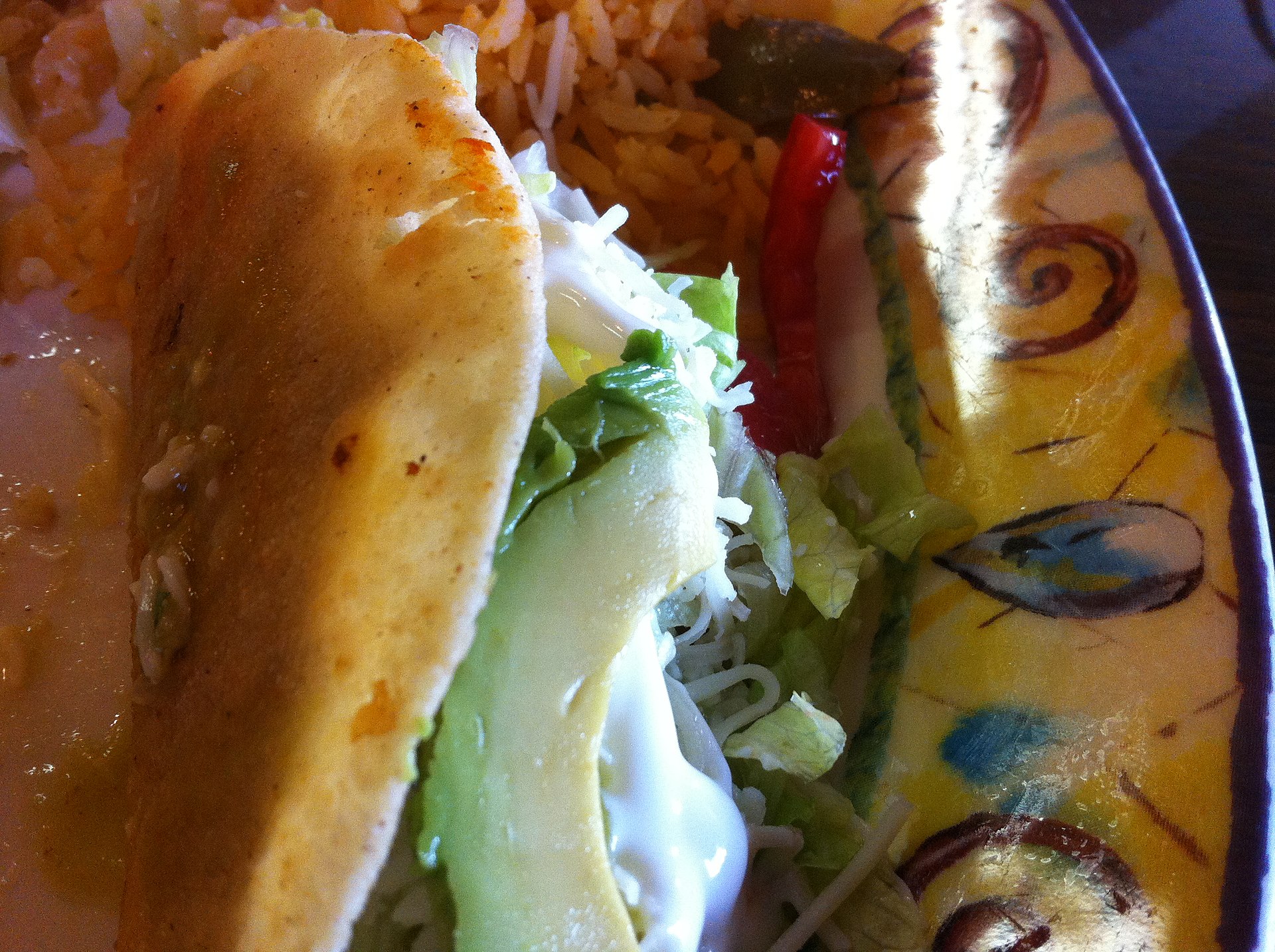 A crisp taco filled with lettuce and cheese
